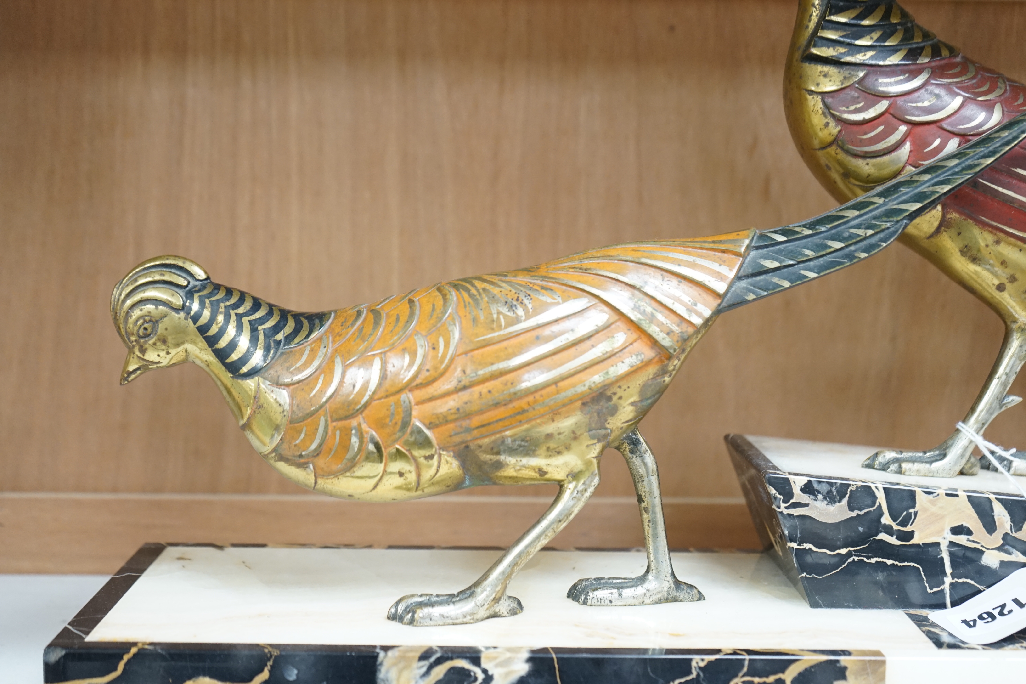 An Art Deco patinated bronze model of two pheasants on marble base, stamped ‘bronze’ and signed ‘Hugues’, 70cm long